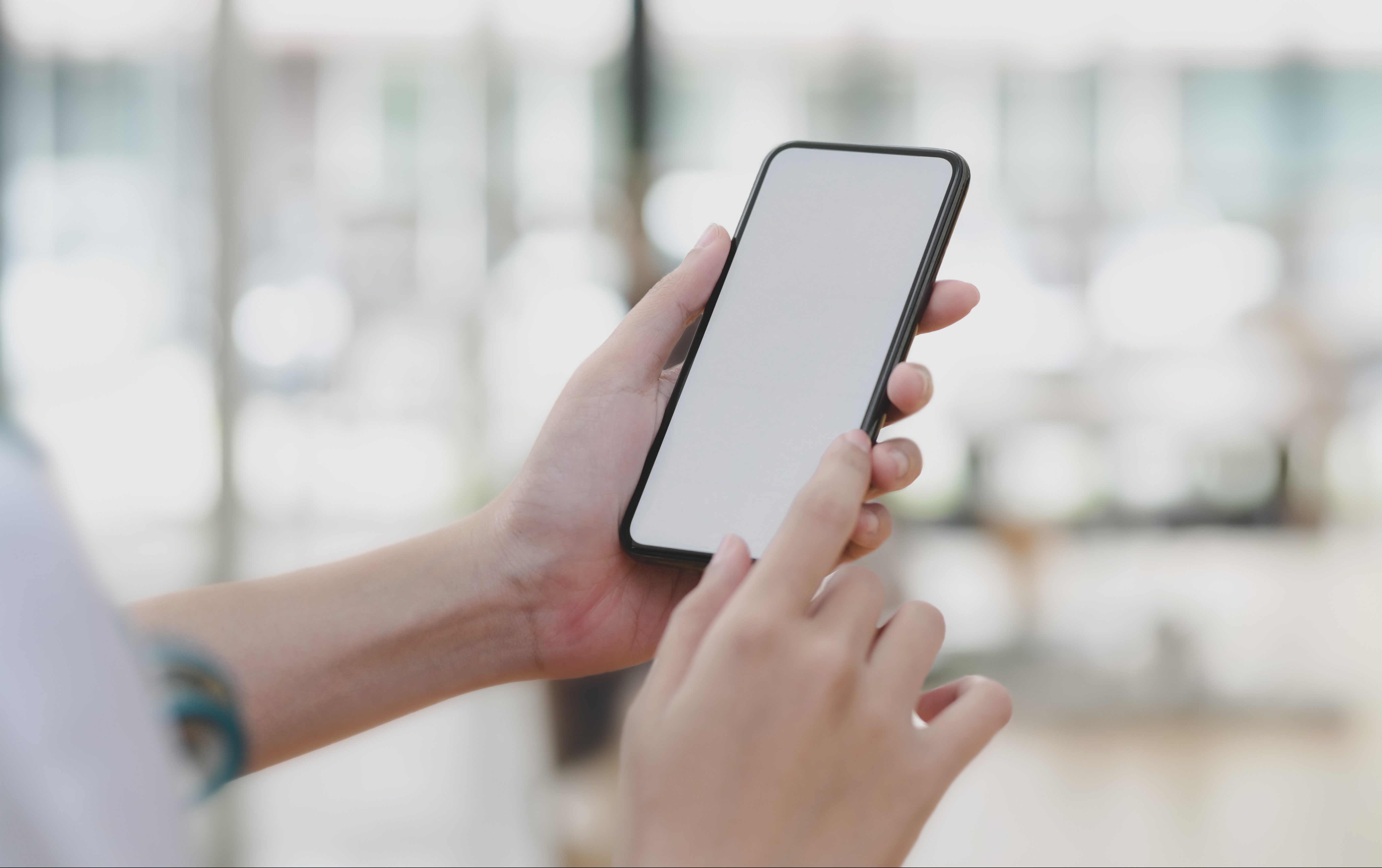 Cropped shot of young female professional doctor using her smartphone